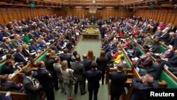 FILE - Britain's Prime Minister Theresa May addresses the House of Commons on her government's reaction to the poisoning of former Russian intelligence officer Sergei Skripal and his daughter Yulia in Salisbury, in London, March 14, 2018. 