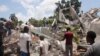 FILE - People search through the rubble of what used to be the Manguier Hotel after the earthquake hit on August 14, 2021 in Les Cayes, southwest Haiti.