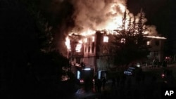 Flames rise from a fire in a school dormitory in Aladag, Adana, in southern Turkey, Nov. 29, 2016. 