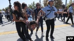 Riot police officers detain a protester during the trial of two Turkish educators, who went on a hunger strike over their dismissal under a government decree following last year's failed coup, outside a courthouse in Ankara, Turkey, Sept. 14, 2017.