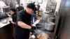 FILE - Tito Thepkaysone cooks pad Thai at "Love & Thai" restaurant in Fresno, California, Dec. 20, 2023. The Thai restaurant was wrongfully accused of abusing a dog to turn it into meat, a false claim rooted in a racist stereotype.