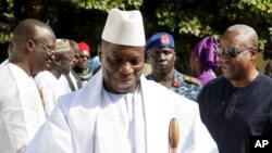 FILE - In this photo released by the Nigeria State House, Gambia's Yahya Jammeh, walk along side with Nigeria President Muhammadu Buhari (not seen), upon arrival in Banjul, Jan.13, 2017. 