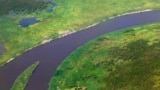 FILE - An aerial view shows settlements set up along the banks of river Nile by people displaced by fighting between the government army and rebels in Bor, Dec. 25, 2013.