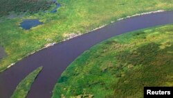 FILE - An aerial view shows settlements set up along the banks of river Nile by people displaced by fighting between the government army and rebels in Bor, Dec. 25, 2013.