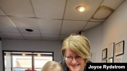 Alta, Iowa, hairstylist Joyce Rydstrom, shown in her salon with her granddaughter, says her emergency fund is shrinking while her salon remains closed because of the coronavirus pandemic.