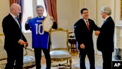 Le président argentin Mauricio Macri, deuxième à gauche, contemple un maillot avec son nom près du président de la Fifa Gianni Infantino, à gauche, aux côtés du président paraguayen Horacio Cartes, deuxième à droite, et son homologue uruguayen Tavare Vazq