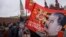 Communist party supporters carry flags with portraits of Soviet dictator Josef Stalin during a demonstration marking the 100th anniversary of the 1917 Bolshevik revolution in Red Square, in Moscow, Russia, Nov. 5, 2017. 