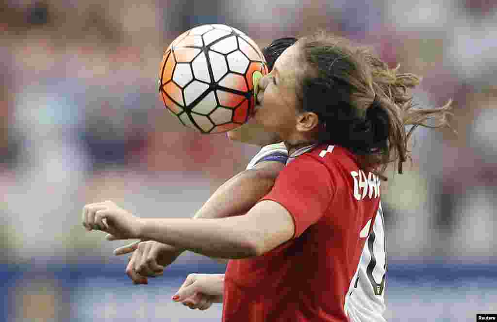 Feb 21, 2016; Houston, TX, USA; Canada forward Christine Sinclair (12) and USA midfielder Carli Lloyd (10) head the ball in the second half during the 2016 CONCACAF women&#39;s Olympic soccer tournament at BBVA Compass Stadium. (Credit: Thomas B. Shea/USA TODAY Sports)