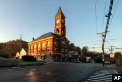 Town Hall catches the early morning sunlight, Thursday, Nov. 16, 2023, in Hinsdale, N.H. The small town in southwestern New Hampshire received a gift of $3.8 million from the estate of Geoffrey Holt, a longtime trailer park resident. (AP Photo/Robert F. Bukaty)