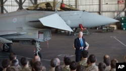 British Defense Minister Michael Fallon talks to British pilots and soldiers at RAF Akrotiri, a British air base near Limassol, Cyprus, Dec. 5, 2015. British warplanes at RAF Akrotiri carried out airstrikes in Syria Thursday. 