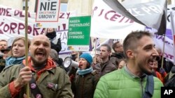 CETA Trade Deals: Protesters shout slogans during a march against trade deals with Canada and the U.S. in Warsaw, Poland, Saturday, Oct. 15, 2016.