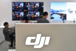 FILE - People are seen in a DJI store in Shanghai, May 22, 2019.