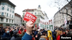 Demonstrators attend an anti-government protest in Ljubljana, Slovenia, April 27, 2021. 