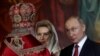 RUSSIA -- Russian President Vladimir Putin reacts next to Svetlana Medvedeva, wife of the prime minister, as Russian Orthodox Church Patriarch Kirill conducts the Orthodox Easter service at the Cathedral of Christ the Saviour in Moscow, April 28, 2019