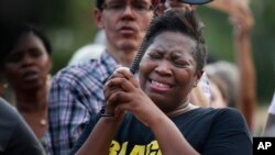 Cara McClure, of Birmingham, Alabama, cries during a solidarity gathering Aug. 13, 2017, in Birmingham for the victims in Charlottesville, Virginia.