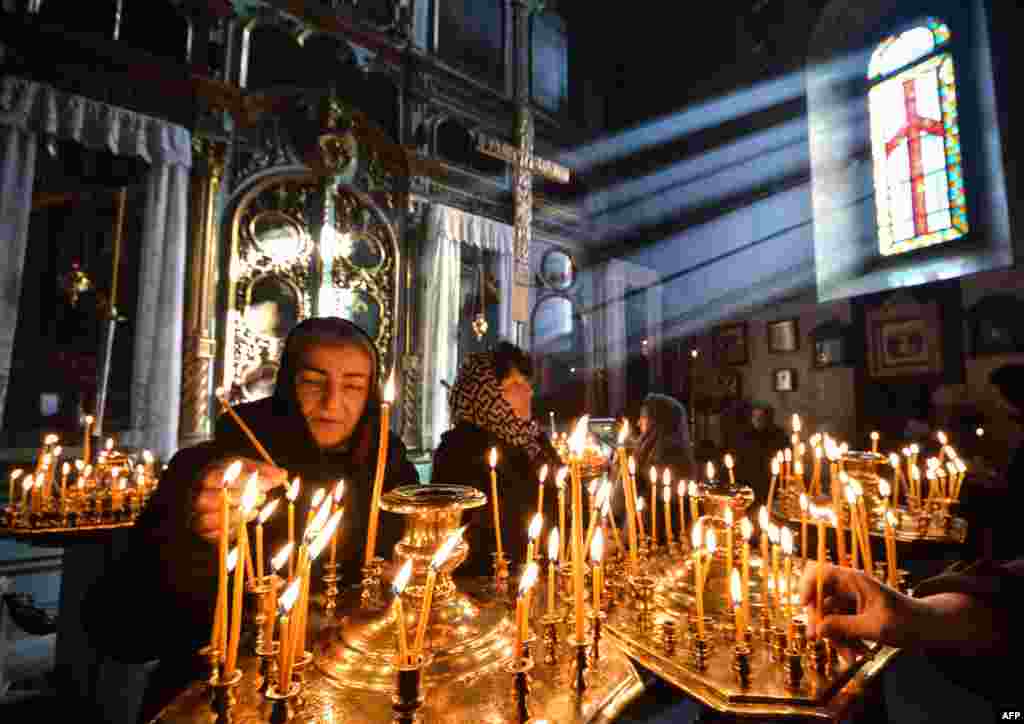 People light candles in a church in downtown Tbilisi, Georgia.