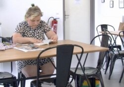 Katazyna Mac studies for final exams at her student housing outside Paris. (Lisa Bryant/VOA)