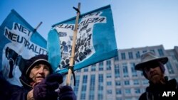 Activists gather before a hearing at the Federal Communications Commission in Washington, D.C., Dec. 14, 2017.