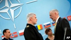 Chairman of the Military Committee, Gen. Petr Pavel, center, speaks with U.S. Secretary of Defense Jim Mattis, right, during a meeting at NATO headquarters in Brussels, Feb. 16, 2017.