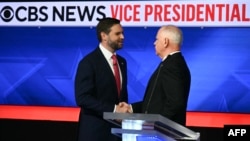 TOPSHOT - US Senator and Republican vice presidential candidate J.D. Vance (L) and Minnesota Governor and Democratic vice presidential candidate Tim Walz shake hands at the end of the Vice Presidential debate hosted by CBS News at the CBS Broadcast Center