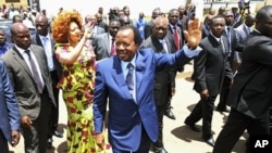 Cameroon's President Paul Biya waves outside a polling center after casting his vote in the capital Yaounde, October 9, 2011.