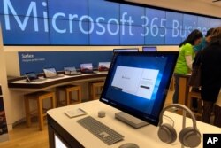 In this Tuesday, Jan. 28, 2020, photo a Microsoft computer is among items displayed at a Microsoft store in suburban Boston. Microsoft reports financial results on Jan. 29, 2020.