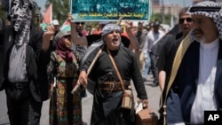 FILE - Palestinians participate in a rally marking the 75th anniversary of what they call the "Nakba," or "catastrophe", in the West Bank city of Ramallah, May 15, 2023