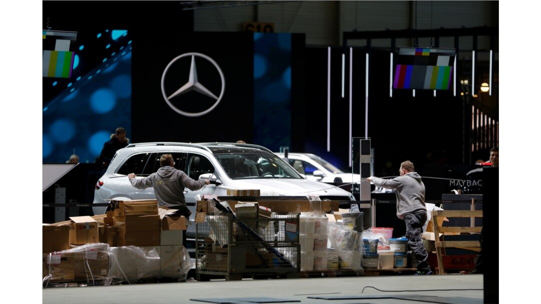 Cars and workers are pictured at the Palexpo exhibition center as the 90th edition of the International Motor Show is canceled to curb the spread of the coronavirus, in Geneva, Switzerland, Feb. 28, 2020.