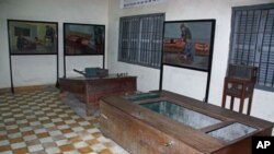 Paintings by human rights icon and artists Vann Nath depicting how torture devices were used hang on the walls of Tuol Sleng Prison in Phnom Penh, Cambodia, June 2011.