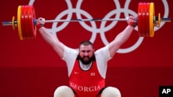 Lasha Talakhadze of Georgia competes in the men's +109kg weightlifting event, at the 2020 Summer Olympics in Tokyo, Japan, Aug. 4, 2021.