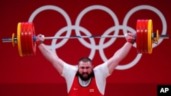 Lasha Talakhadze of Georgia competes in the men's +109kg weightlifting event, at the 2020 Summer Olympics in Tokyo, Japan, Aug. 4, 2021.