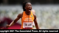 Marie-Josee Ta Lou, of the Ivory Coast, wins a heat in the women’s 100-meter run at the 2020 Summer Olympics, July 30, 2021, in Tokyo. 