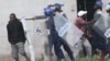 FILE: Armed Zimbabwean police clash with rioters in Harare, Monday, July 4, 2016. (AP Photo/Tsvangirayi Mukwazhi)