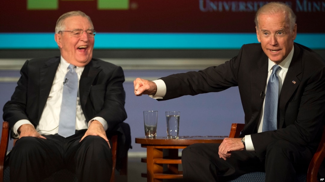 Vice President Joe Biden gestures toward former Vice President Walter Mondale as they participate in a forum honoring Mondale’s legacy, at George Washington University in Washington, Oct. 20, 2015.