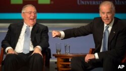 Vice President Joe Biden gestures toward former Vice President Walter Mondale as they participate in a forum honoring Mondale’s legacy, at George Washington University in Washington, Oct. 20, 2015.