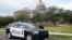 A Capitol Police officer warns off passersby as they respond to a bomb threat at the Mississippi State Capitol in Jackson, Miss., Jan. 3, 2024. The building was emptied and the grounds cleared of vehicles as officers investigated.