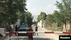 Afghan policemen keep watch near the site of a suicide attack in Kabul, Afghanistan, June 11, 2018. 