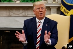 FILE - President Donald Trump speaks during a meeting in the Oval Office of the White House, Aug. 20, 2019.