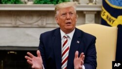 President Donald Trump speaks during a meeting with Romanian President Klaus Iohannis in the Oval Office of the White House, Aug. 20, 2019, in Washington.