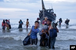 FILE - Rohingya refugees disembark at Ulee Madon, North Aceh, Indonesia, on Nov. 16, 2023.