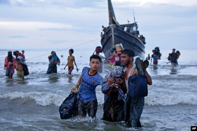 Rohingya refugees reach land at Ulee Madon, North Aceh, Indonesia, on Nov. 16, 2023. Some 250 Rohingya Muslims are afloat off the coast of Indonesia after two attempts to land were rejected by local residents. (AP Photo/Rahmat Mirza)