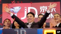 FILE - Liu Qiangdong, also known as Richard Liu, CEO of JD.com, celebrates the IPO for his company at the Nasdaq MarketSite, in New York, May 22, 2014. Minnesota prosecutors decided not to charge Liu after a Chinese college student accused him of sexual assault. 