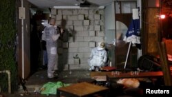 Israeli forensic policemen work at the scene of a shooting incident in Tel Aviv, Israel, on Jan. 1, 2016. 