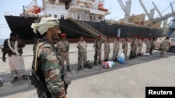 Some of Yemen's Houthi forces are seen withdrawing from Saleef port, in Hodeida province, Yemen, May 11, 2019. 