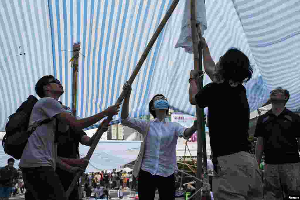 Protesters of the Occupy Central movement set a tent up on a main road at the Mong Kok shopping district in Hong Kong, Oct. 6, 2014.