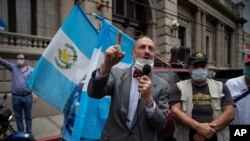 Anti-government activist Fernando Linares speaks in front of the Congress building during a protest to demand that the government lift the coronavirus lockdown, in Guatemala City, Guatemala, June 18, 2020.
