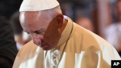 Pope Francis prays in the Wawel Cathedral in Krakow, Poland, July 27, 2016.