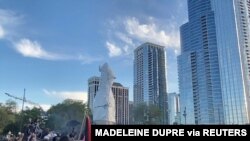 Protesters surround a statue of Christopher Columbus at Grant Park in Chicago, Illinois, July 17, 2020, in this still image from video obtained via social media. (Madeleine Dupre via Reuters) 