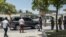 Security officers checks the surroundings of a convoy of dark-colored vehicles as it makes its way to the U.S. embassy in the Tabarre neighborhood of Port-au-Prince, Haiti, July 11, 2021.