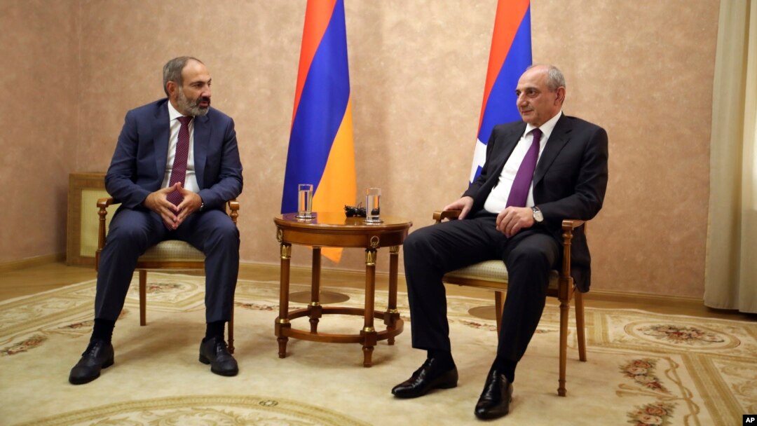 Armenia's Prime Minister Nikol Pashinian, left, and President Bako Sahakyan of the separatist Nagorno-Karabakh region are seen during their meeting in the capital Stepanakert, May 9, 2018. Nagorno-Karabakh, part of Azerbaijan has been under the control of local ethnic Armenian forces and the Armenian military since a war ended in 1994 with no resolution of the region's status.